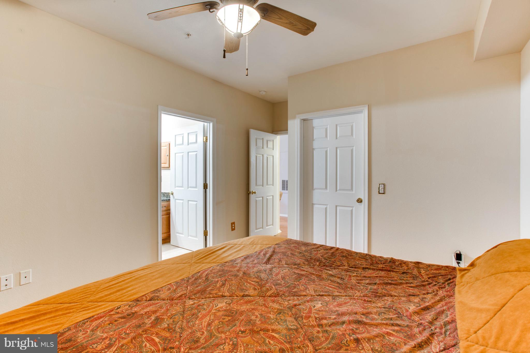 1600 Spring Gate Dr., Unit 2207 McLean, VA 22102 - Photo 16 of 29 a bedroom with a bed and a chandelier