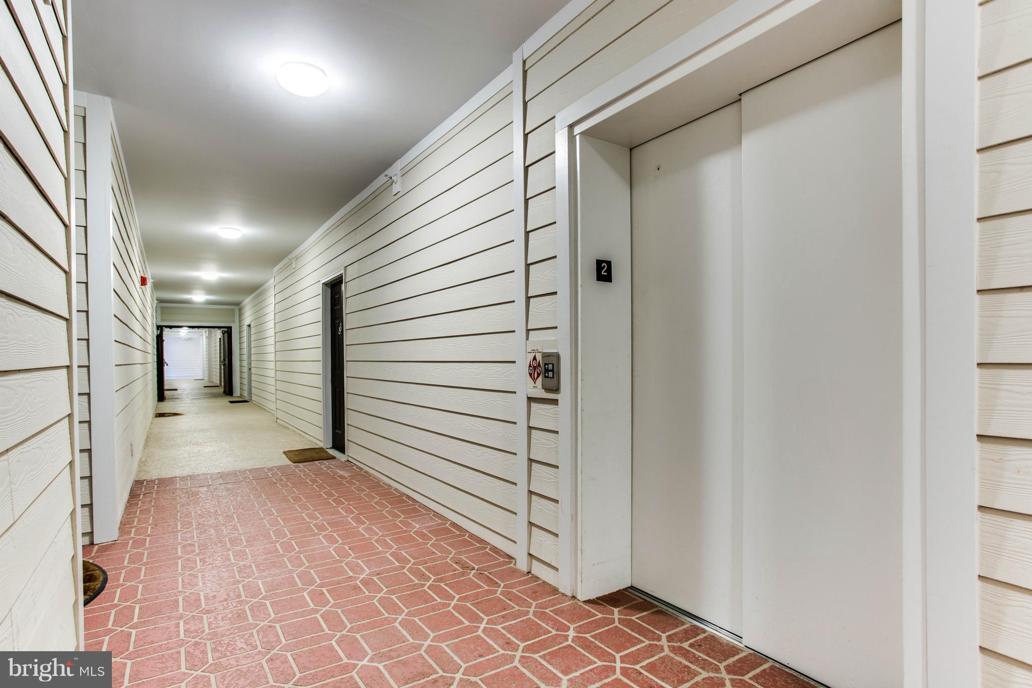 1600 Spring Gate Dr., Unit 2207 McLean, VA 22102 - Photo 3 of 29 a view of a hallway with stairs and door of a house