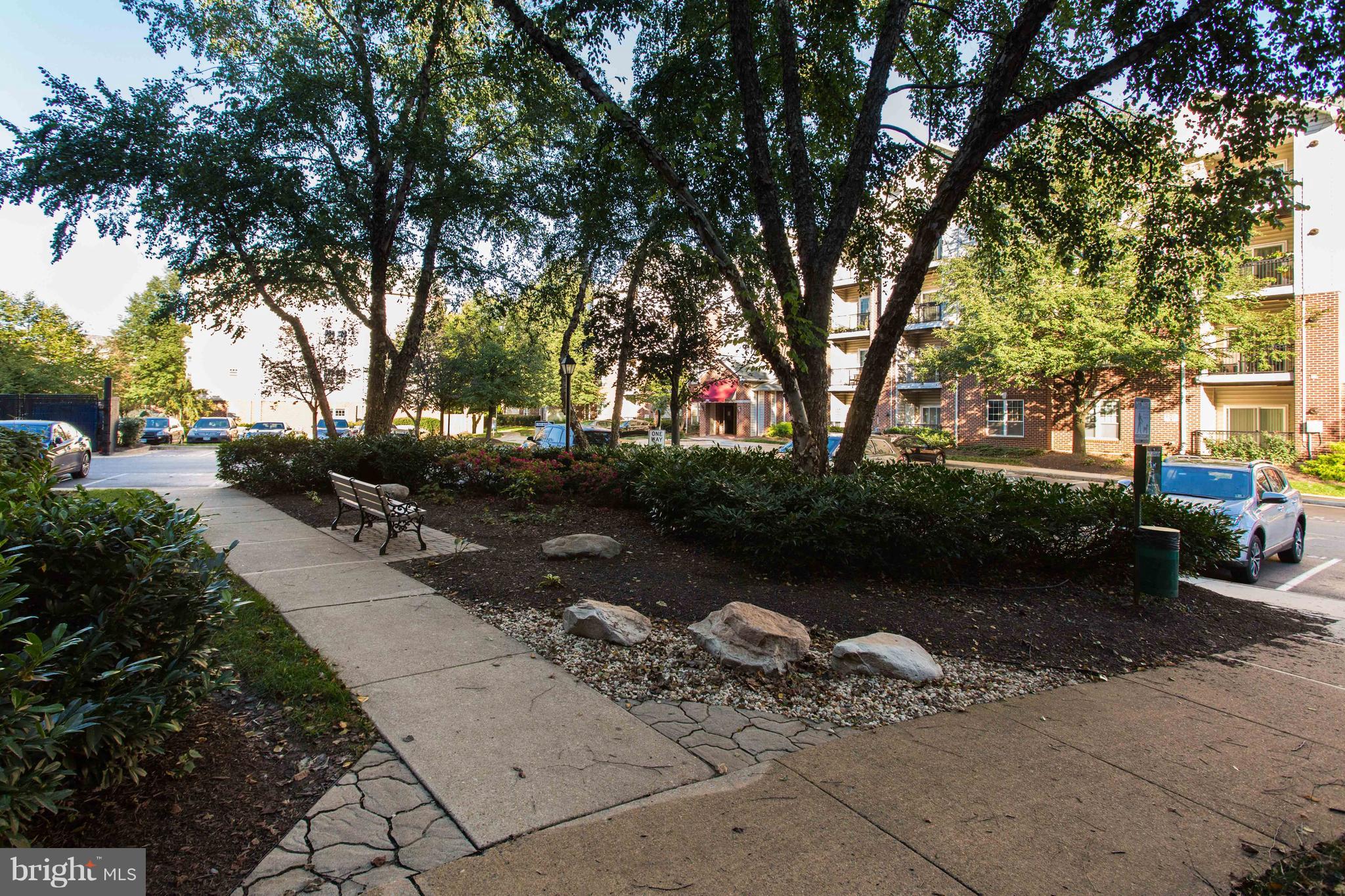 1600 Spring Gate Dr., Unit 2207 McLean, VA 22102 - Photo 27 of 29 a view of a street with a bench and trees