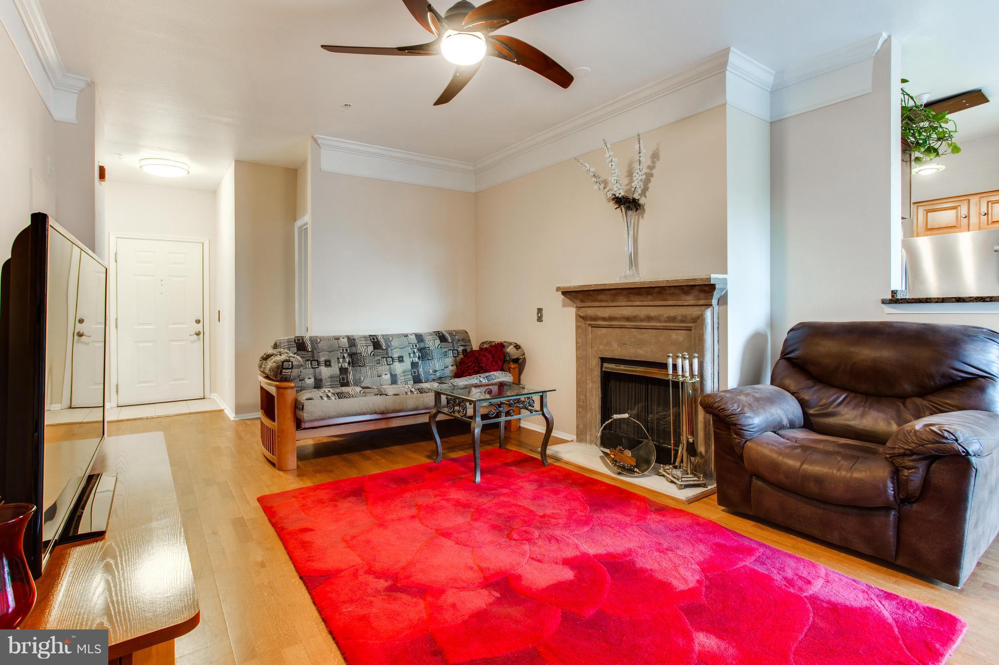 1600 Spring Gate Dr., Unit 2207 McLean, VA 22102 - Photo 7 of 29 a living room with furniture and a fireplace