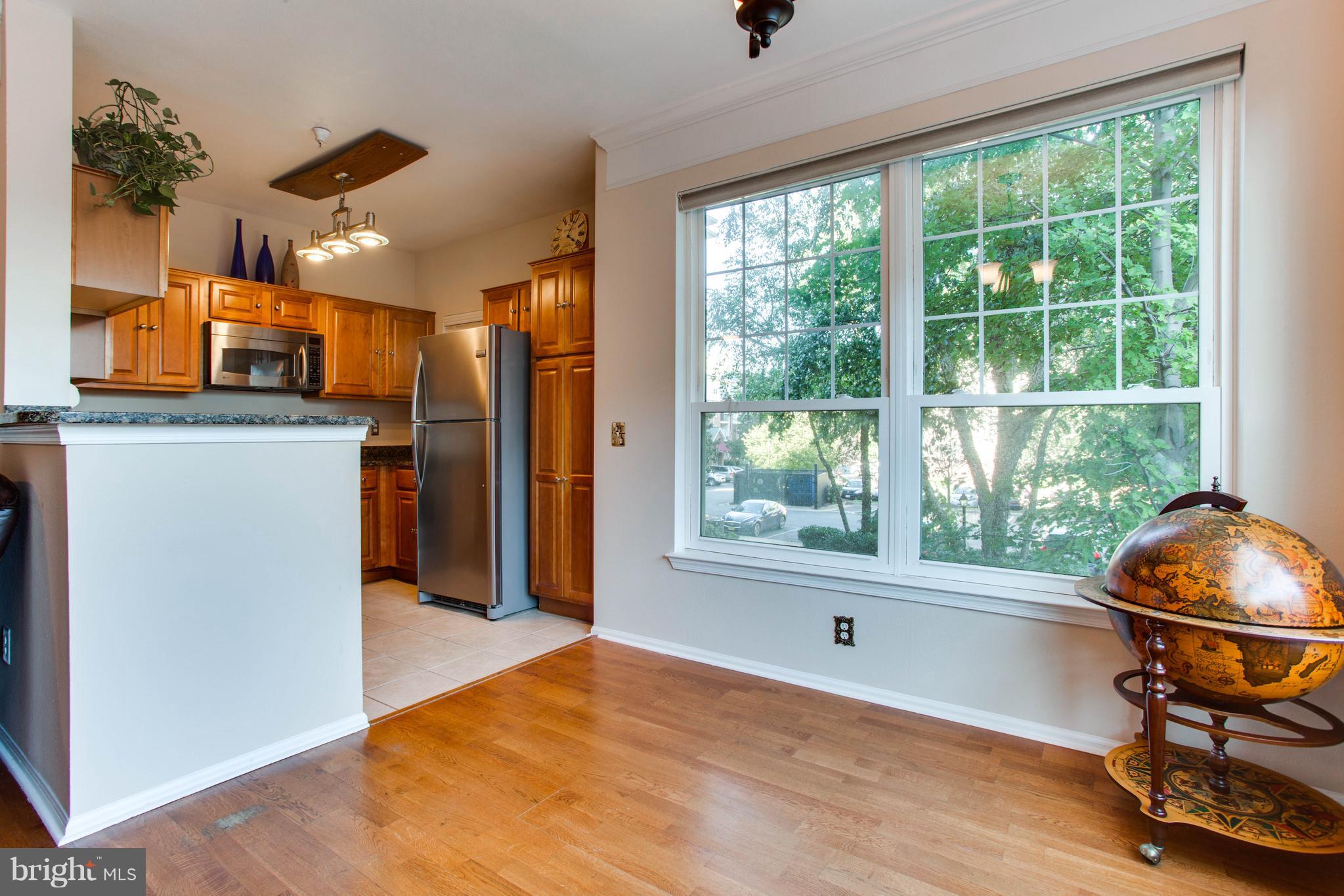 1600 Spring Gate Dr., Unit 2207 McLean, VA 22102 - Photo 10 of 29 a workspace with stainless steel appliances wooden floor and a window