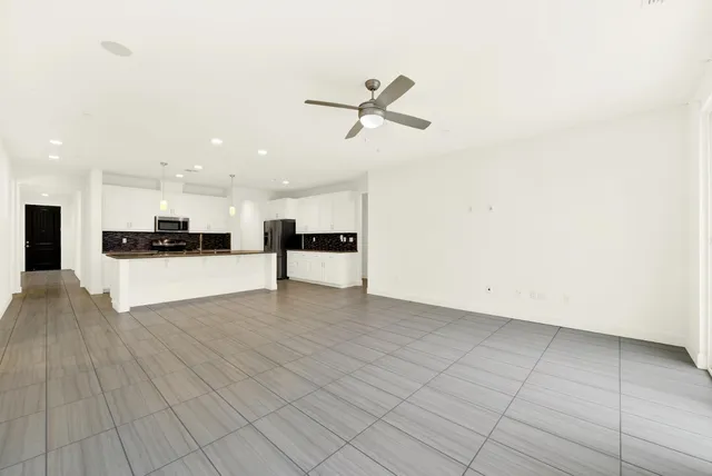 a large kitchen with a stove and a sink