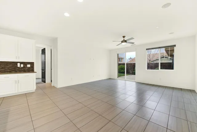 a kitchen with stainless steel appliances granite countertop a sink a stove and a refrigerator