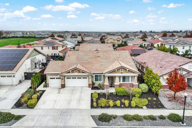 a front view of a building with a garden