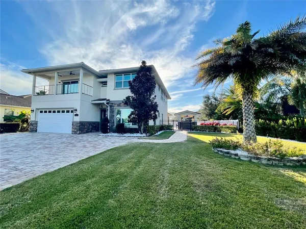 a view of a house with swimming pool and a yard