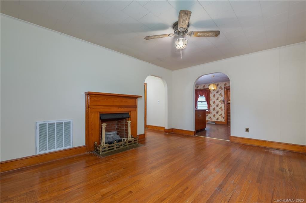 428 Kelly Road Forest City, NC 28043 - Photo 11 of 24 wooden floor fireplace and windows in an empty room