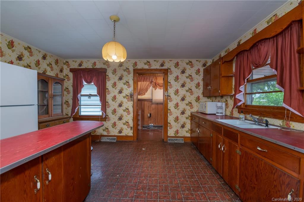428 Kelly Road Forest City, NC 28043 - Photo 14 of 24 a kitchen with stainless steel appliances granite countertop a stove a sink dishwasher and a refrigerator