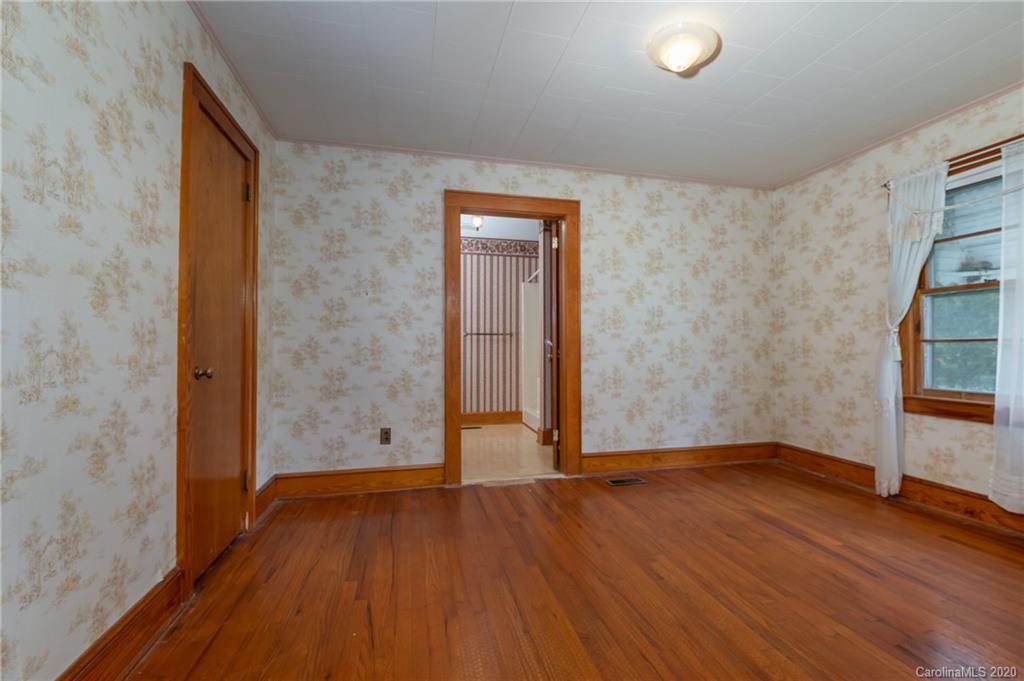 428 Kelly Road Forest City, NC 28043 - Photo 21 of 24 an empty room with wooden floor and windows