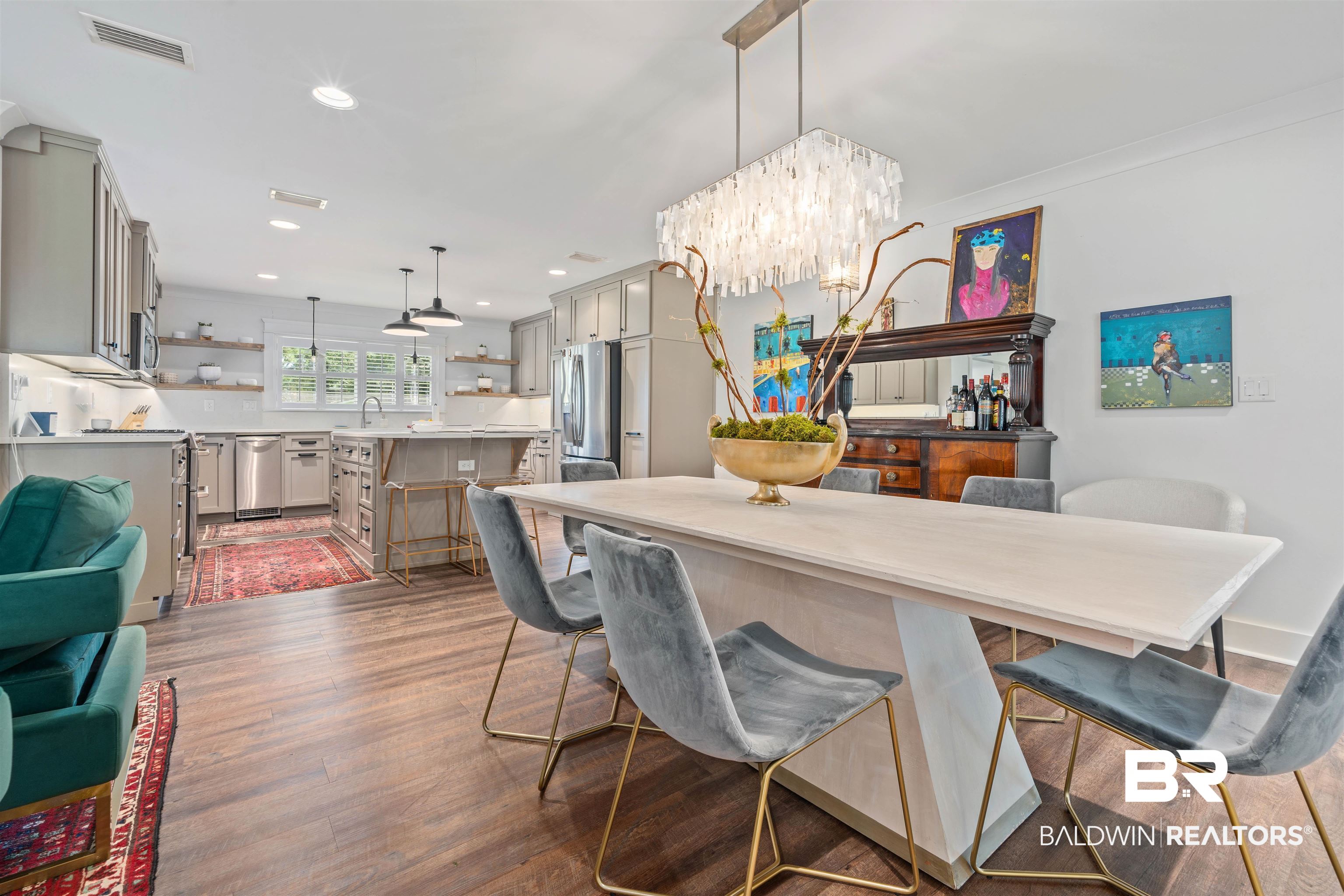 3808 Claridge Road North Mobile, AL 36608 - Photo 16 of 43 Dining space featuring sink, an inviting chandelier, and hardwood / wood-style floors