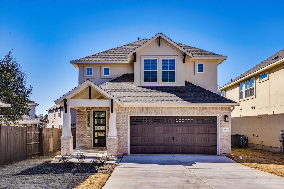 Craftsman house featuring a shingled roof, concrete driveway, a garage, brick siding, and stucco siding