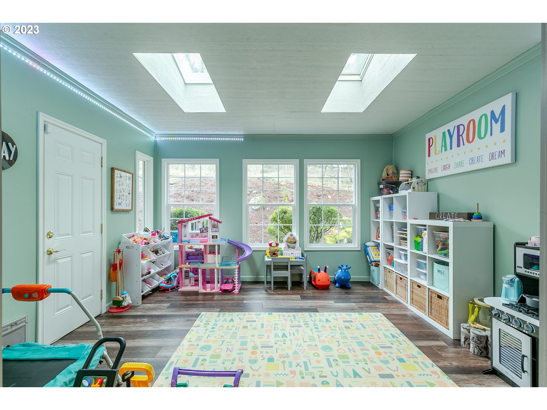 2353 35th Street Springfield, OR 97477 - Photo 16 of 32 a living room with furniture toys and a large window
