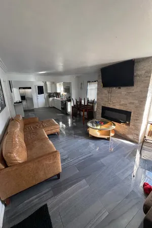 a living room with furniture fireplace and flat screen tv