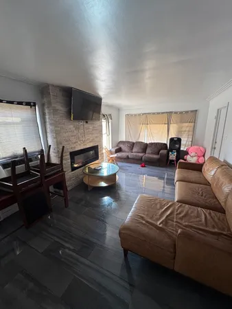 a living room with furniture fireplace and a flat screen tv