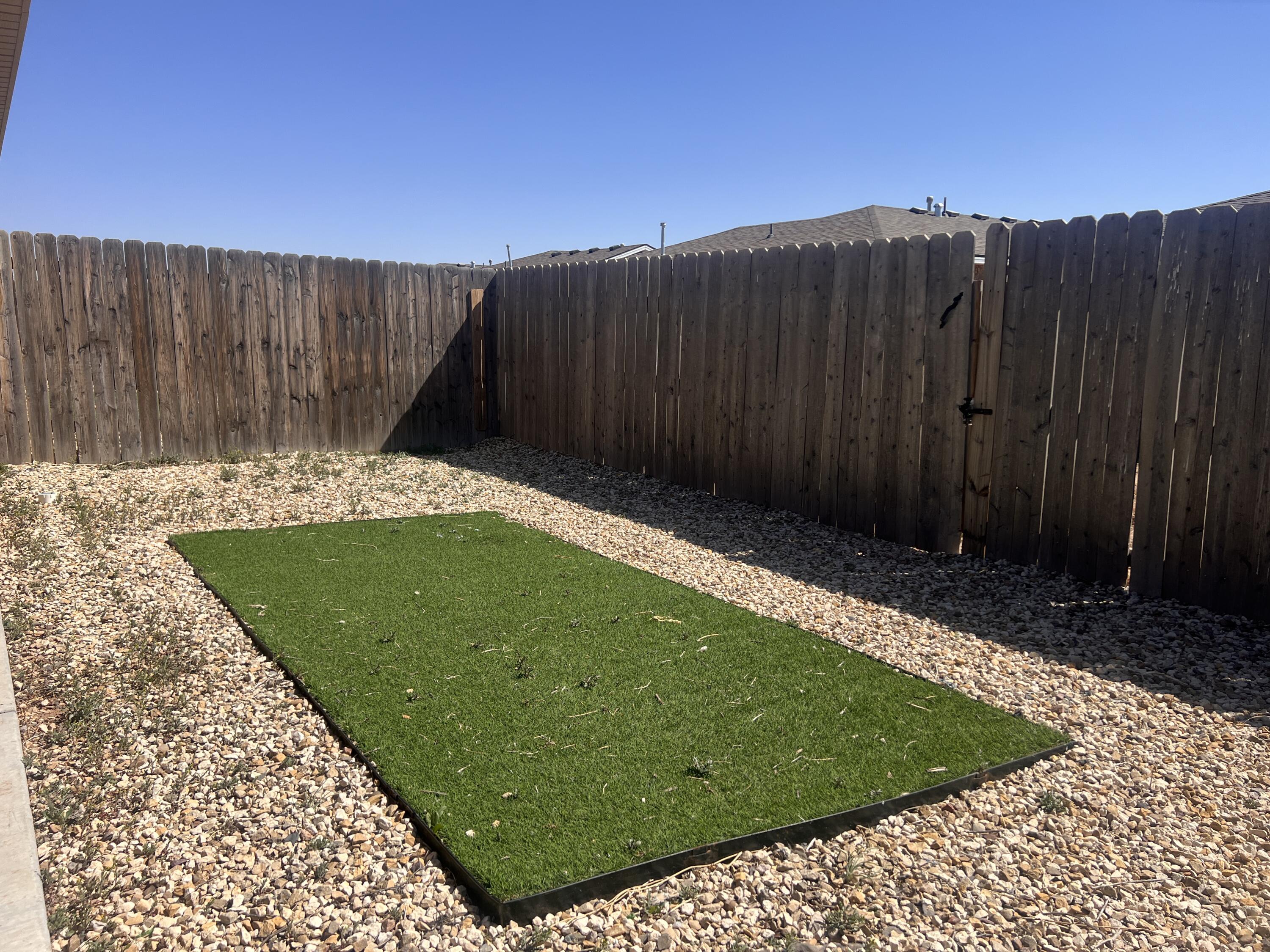1637 133rd Street, Unit B Lubbock, TX 79423 - Photo 18 of 19 a view of a backyard with a wooden fence
