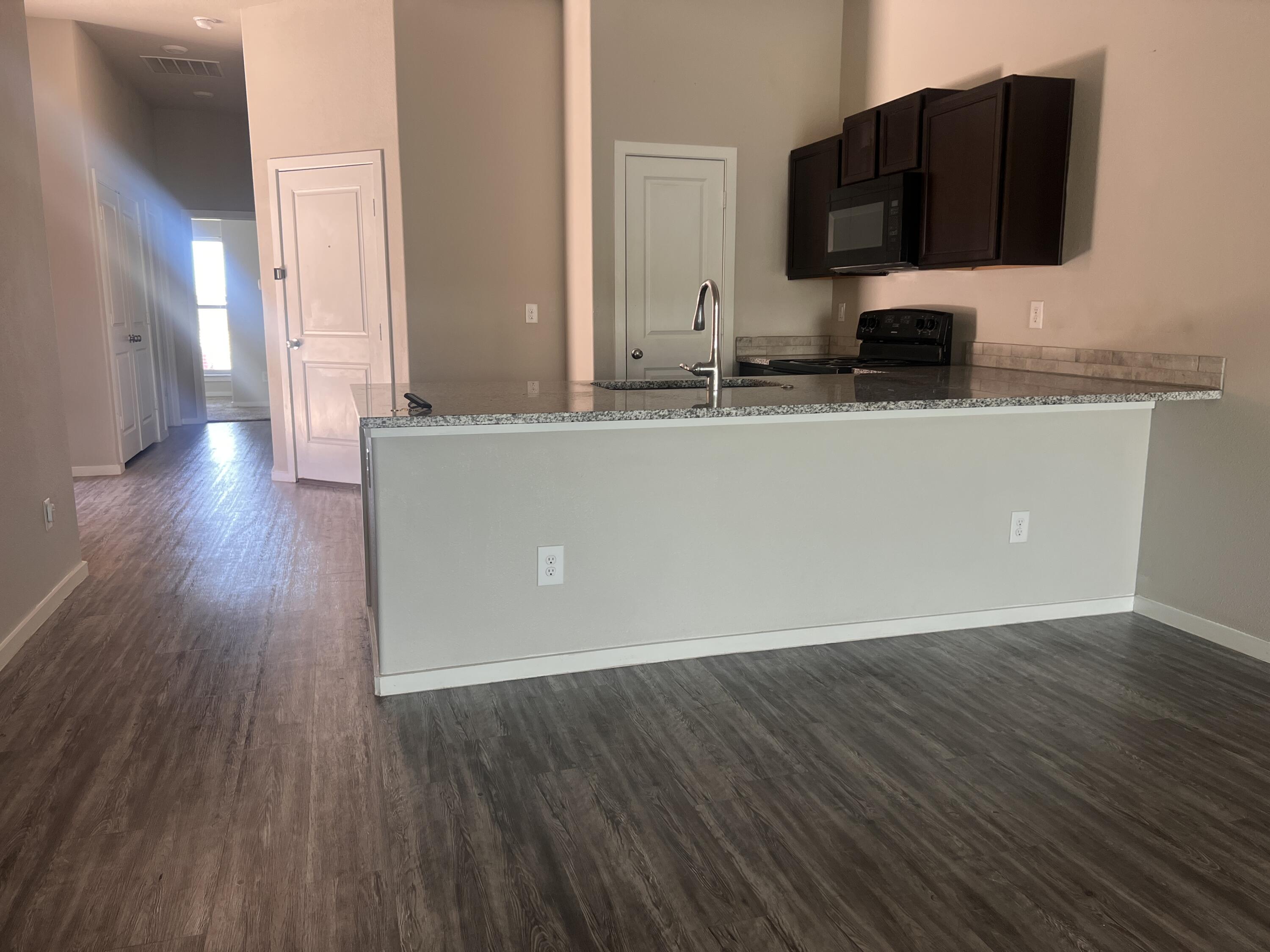 1637 133rd Street, Unit B Lubbock, TX 79423 - Photo 5 of 19 a living room with hard wood floors and a fireplace