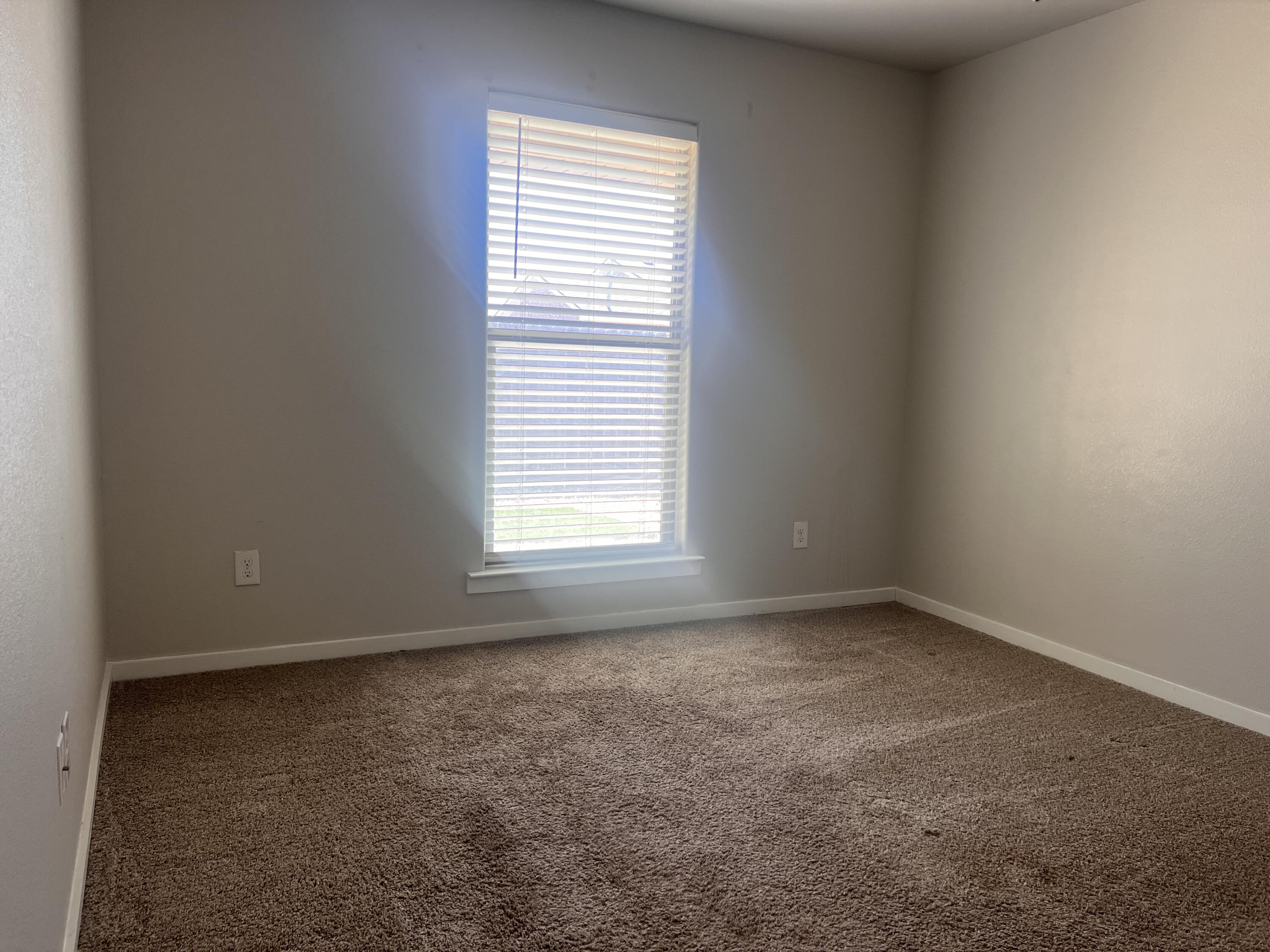 1637 133rd Street, Unit B Lubbock, TX 79423 - Photo 7 of 19 an empty room with a window