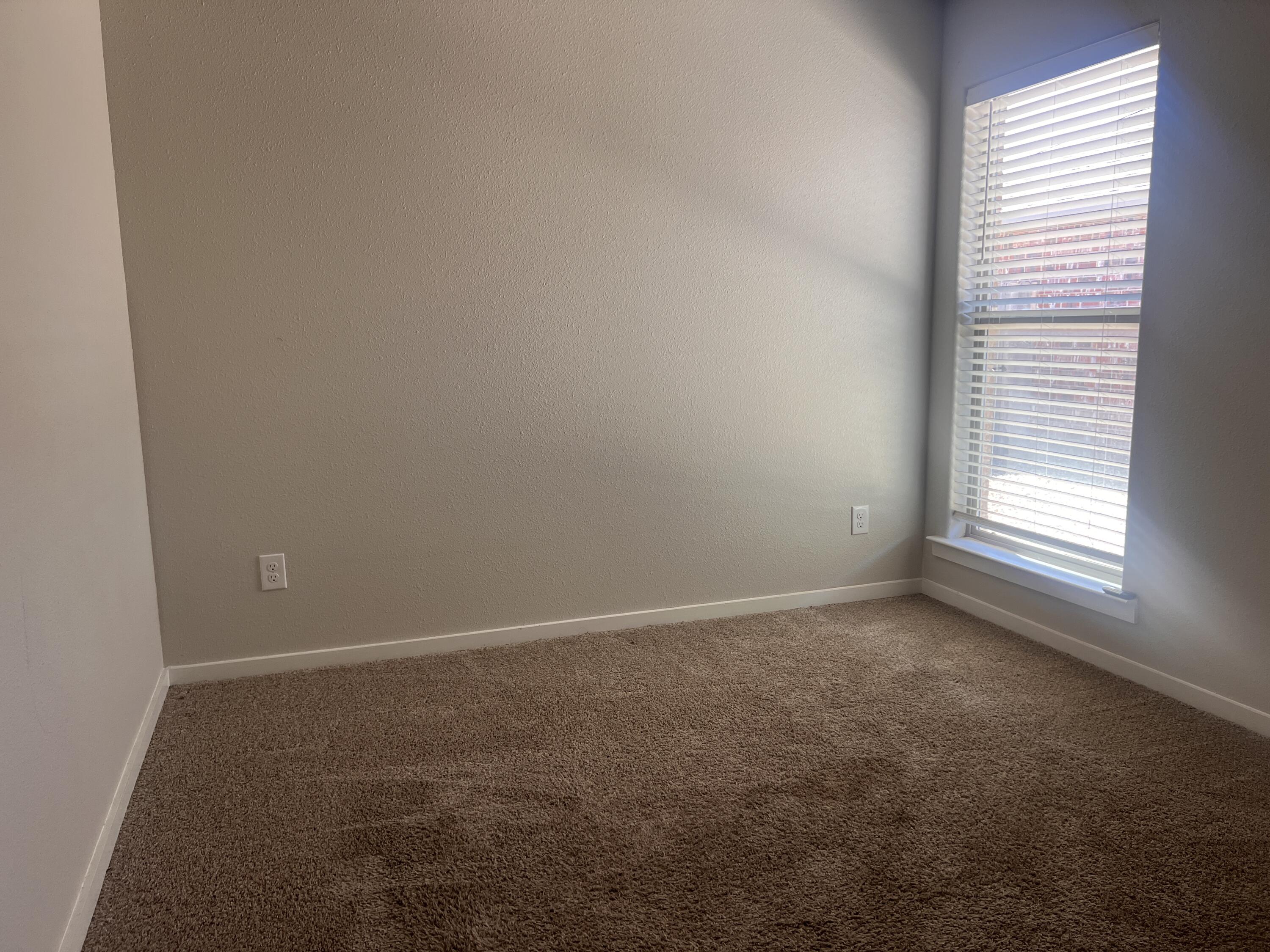 1637 133rd Street, Unit B Lubbock, TX 79423 - Photo 10 of 19 an empty room with a window