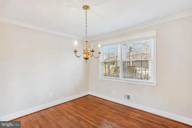 a kitchen with stainless steel appliances granite countertop wooden cabinets a sink and dishwasher a stove top oven with wooden floor