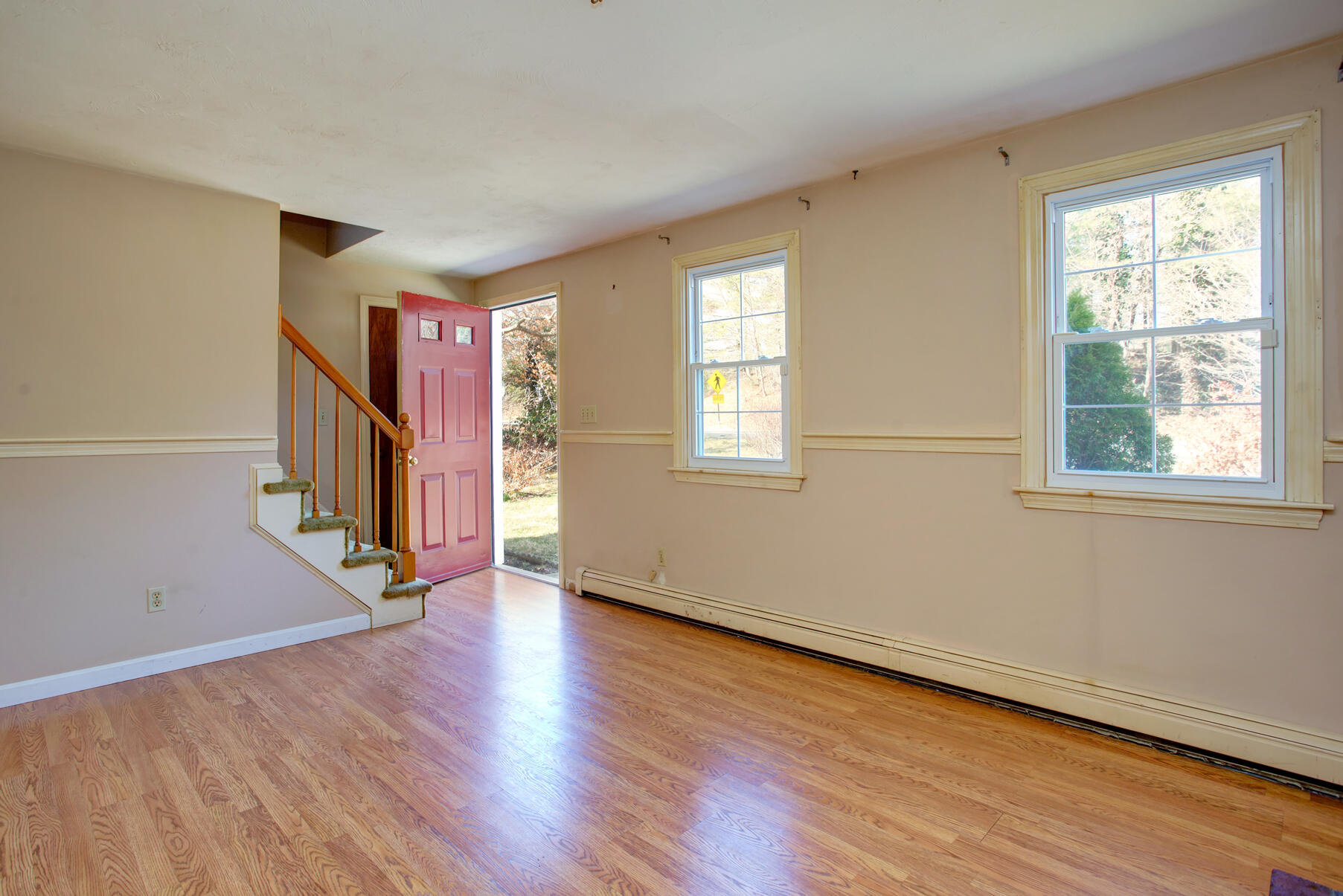 319 Cotuit Road Mashpee, MA 02649 - Photo 8 of 28 a view of an empty room with wooden floor and a window