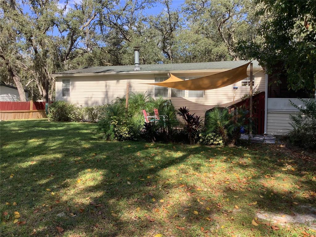 34926 Punch Road Dade City, FL 33523 - Photo 19 of 75 a view of a backyard with large trees