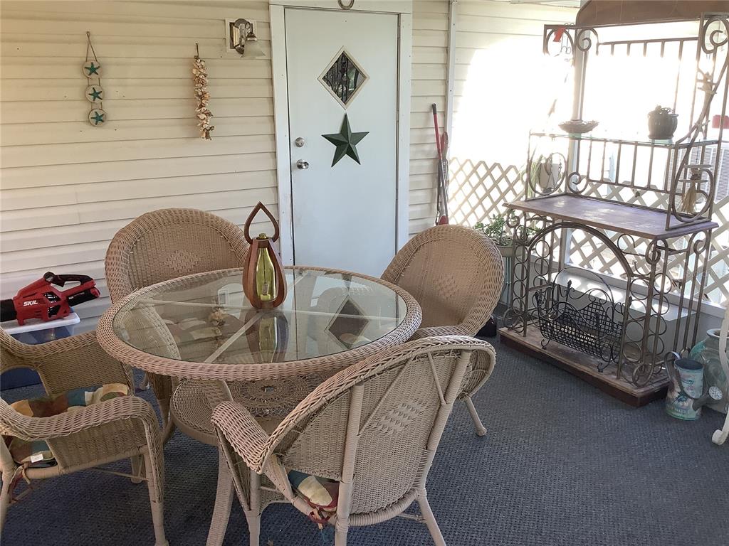34926 Punch Road Dade City, FL 33523 - Photo 29 of 75 a table and chairs in a balcony