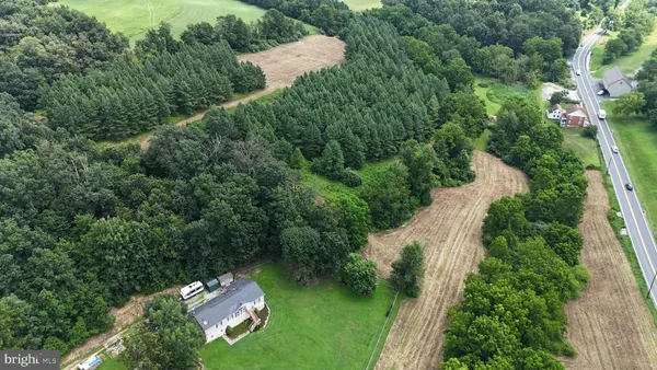 an aerial view of a house with a yard basket ball court and outdoor seating