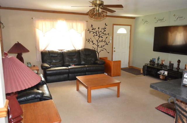 458 East Briarcliff Road Bolingbrook, IL 60440 - Photo 2 of 18 a living room with furniture and a flat screen tv