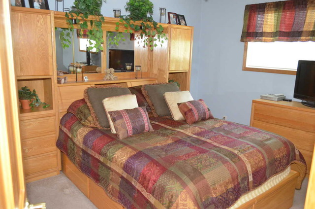 458 East Briarcliff Road Bolingbrook, IL 60440 - Photo 8 of 18 a bedroom with a bed and a flat screen tv