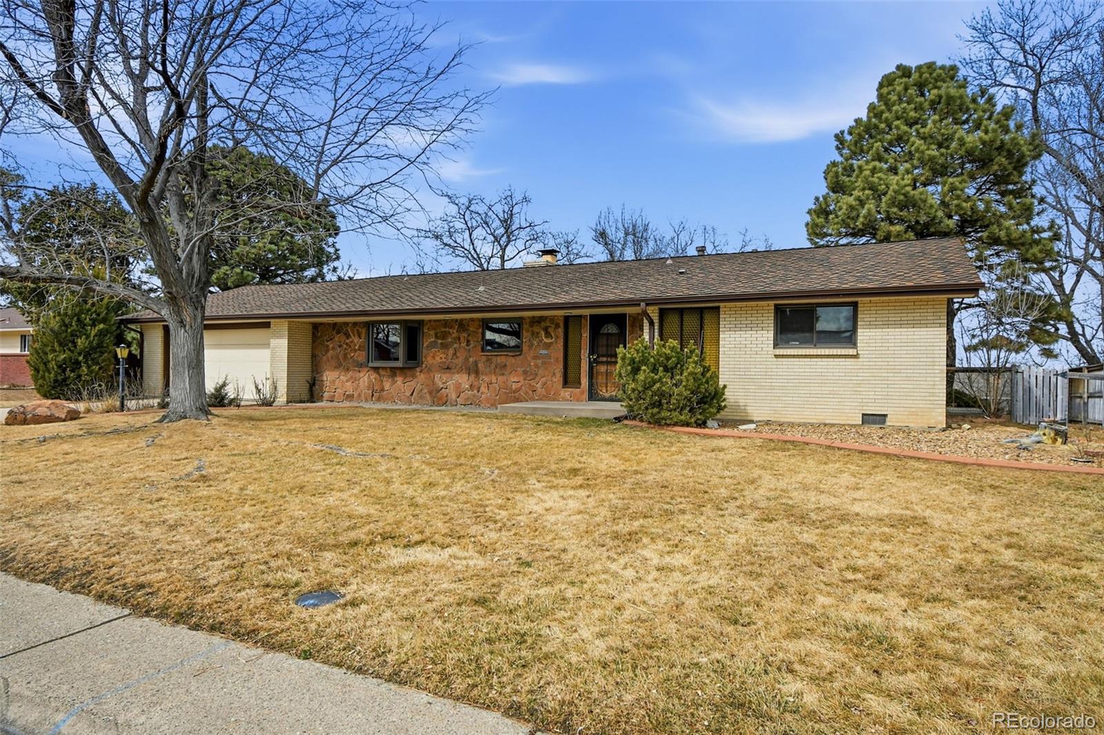 12487 West 38th Drive Wheat Ridge, CO 80033 - Photo 1 of 2 a front view of a house with a garden