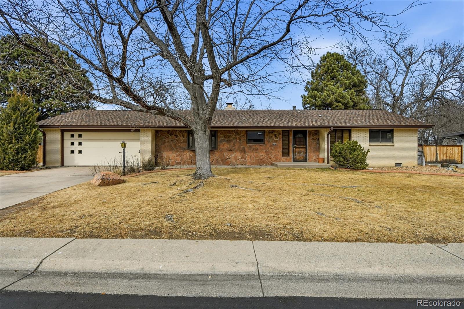 12487 West 38th Drive Wheat Ridge, CO 80033 - Photo 2 of 2 front view of a house with a yard