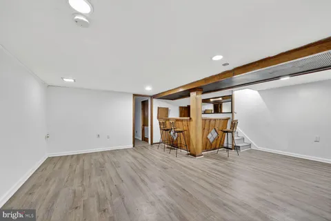 a big room with wooden floor and furniture