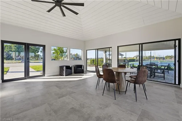 a dining room with furniture a fireplace and a floor to ceiling window