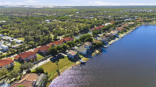 an aerial view of a city with lots of residential buildings ocean and mountain view