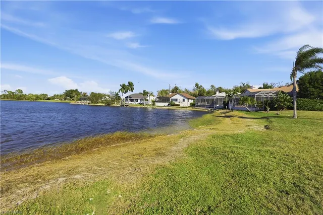 a view of a lake with houses in the back