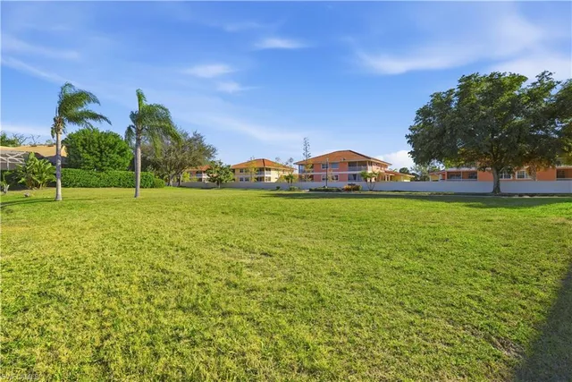 a view of yard with swimming pool and green space