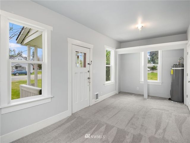 an empty room with windows and closet