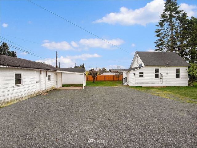 a view of a house with a backyard and a garage
