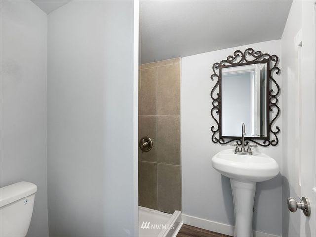 a bathroom with a sink mirror and toilet