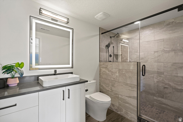 4499 North Seven Bridges Road, Unit 9 Eden, UT 84310 - Photo 44 of 65 Vanity with a rectangular vessel sink, dark countertop, and white cabinetry