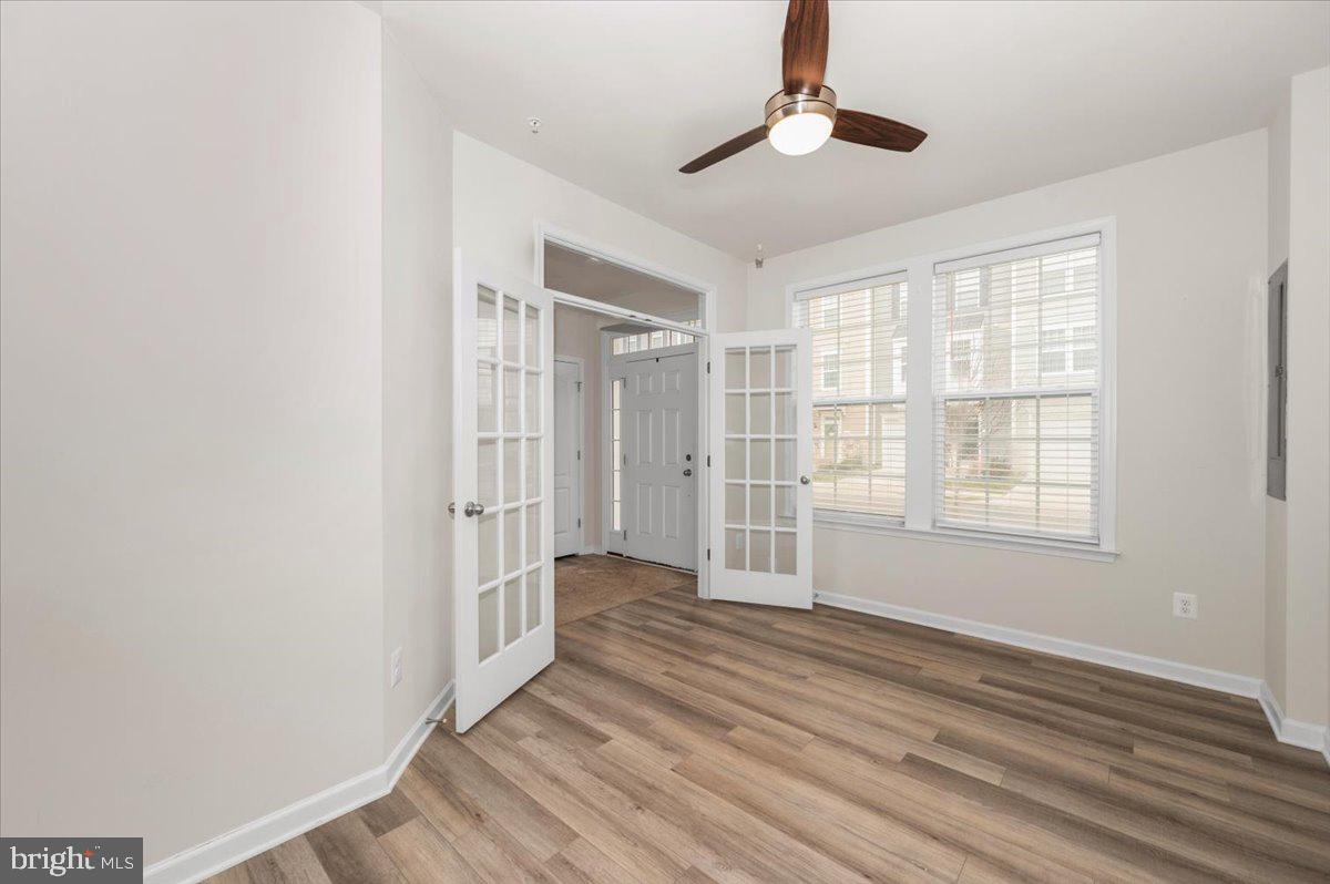 324 Spring Bank Way Frederick, MD 21701 - Photo 35 of 48 an empty room with wooden floor cabinet and windows