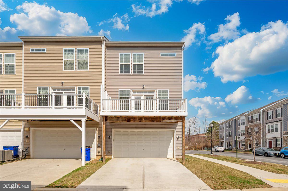 324 Spring Bank Way Frederick, MD 21701 - Photo 40 of 48 a front view of a building with a garden