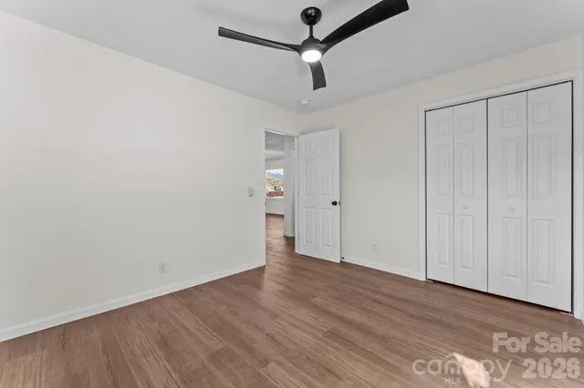 a front view of a house with a yard covered in snow