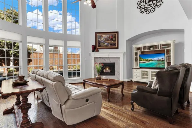 a living room with furniture kitchen view and a table