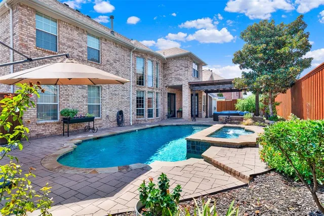 a backyard of a house with outdoor seating and green space