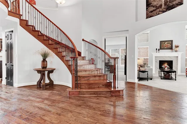 a view of entryway and hall with wooden floor