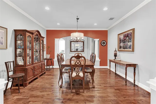 a view of a a dining room with furniture window and wooden floor