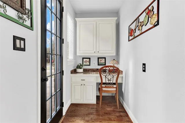a living room with furniture two windows and a fireplace