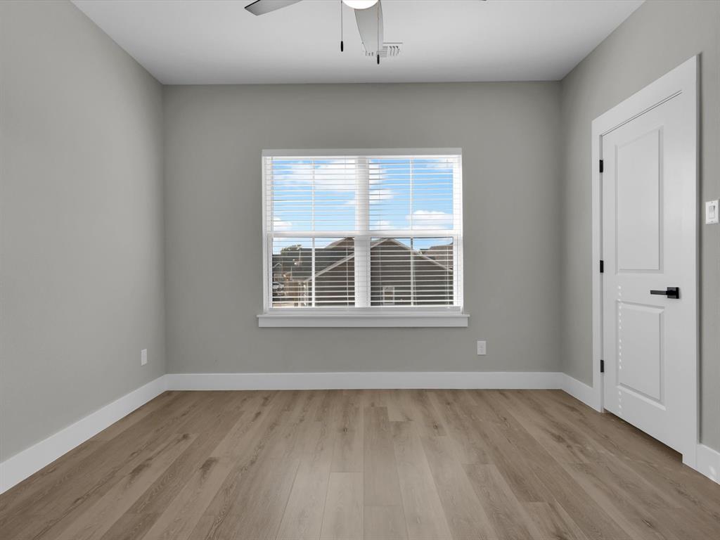 4905 Sweetbay Road Sherman, TX 75092 - Photo 22 of 26 an empty room with wooden floor and windows