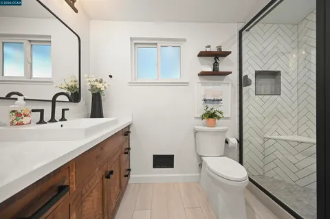 a bathroom with a sink a toilet and shower curtain