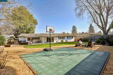 a view of a house with swimming pool and sitting area